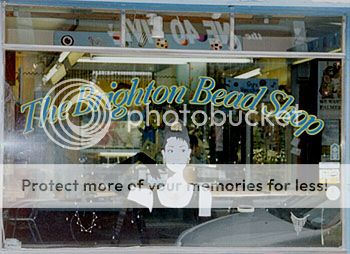 Photo of the window of Brighton Bead Shop, with a cut-out head and shoulders of Audrey Hepburn as Holly Golightly in Breakfast at Tiffany's.